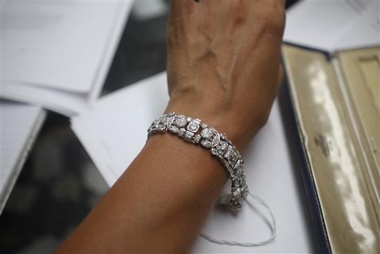 An attractive 1930s/1940s Art Deco white gold and diamond encrusted bracelet in Jays of London fitted box, 7in.